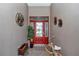 Inviting foyer features decorative art, a vibrant front door, and a vintage bicycle at 1443 Sw 161St St, Ocala, FL 34473