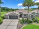 Beautiful home showcasing lush landscaping, mature palm trees, and well-maintained lawn at 1443 Sw 161St St, Ocala, FL 34473
