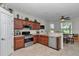 Well-lit kitchen featuring stainless steel appliances, wood cabinets, and breakfast nook at 1443 Sw 161St St, Ocala, FL 34473