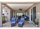 Covered outdoor patio with ceiling fan and outdoor seating at 1443 Sw 161St St, Ocala, FL 34473