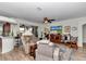 Bright living room with wood floors, comfortable seating, and entertainment center, adjacent to the kitchen at 1443 Sw 161St St, Ocala, FL 34473