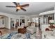 Inviting living room with wood floors and large blue rug, seamlessly connected to kitchen and dining areas at 1443 Sw 161St St, Ocala, FL 34473