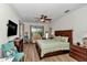 Spacious main bedroom boasts wood floors, ceiling fan, and a sitting area at 1443 Sw 161St St, Ocala, FL 34473