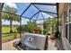 Outdoor grill on a screened patio with plants and tile flooring at 1443 Sw 161St St, Ocala, FL 34473