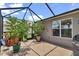 Outdoor screened patio with plants and tile flooring at 1443 Sw 161St St, Ocala, FL 34473