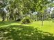 Lush backyard with mature trees providing ample shade, creating a tranquil atmosphere and a great place to unwind at 1523 Se 80Th St, Ocala, FL 34480