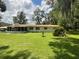 Spacious backyard featuring a screened-in porch and lush green lawn, perfect for outdoor activities and relaxation at 1523 Se 80Th St, Ocala, FL 34480