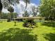 Backyard featuring a screened-in porch, lush green lawn, and trees creating a tranquil atmosphere at 1523 Se 80Th St, Ocala, FL 34480