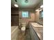 Bathroom featuring a granite countertop and tiled shower with built-in shelves at 1523 Se 80Th St, Ocala, FL 34480