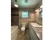 Bathroom featuring a granite countertop and tiled shower with built-in shelves at 1523 Se 80Th St, Ocala, FL 34480
