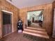 The entryway has a small staircase, wood paneling, and transitions into the living room at 1523 Se 80Th St, Ocala, FL 34480