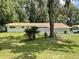 Charming one-story home with a well-maintained lawn and decorative cinder block privacy wall at 1523 Se 80Th St, Ocala, FL 34480
