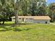 Inviting one-story home with a decorative cinder block privacy wall and a lush green lawn at 1523 Se 80Th St, Ocala, FL 34480