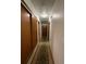 Hallway featuring wood floors and multiple doors at 1523 Se 80Th St, Ocala, FL 34480
