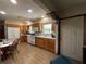 Traditional kitchen with wood cabinetry, white appliances, and a cozy breakfast table near the window at 1523 Se 80Th St, Ocala, FL 34480
