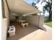 Outdoor patio area with a covered roof and a picnic table, complete with decorative privacy screening at 1523 Se 80Th St, Ocala, FL 34480