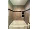 Modern tiled shower featuring built-in shelves and a handheld shower head at 1523 Se 80Th St, Ocala, FL 34480