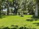 Expansive, sun-drenched backyard featuring lush green grass and mature trees at 1523 Se 80Th St, Ocala, FL 34480