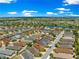 An aerial view showcases the community featuring mature trees and landscaping as well as multiple ponds throughout at 1751 Brandenburg Ct, The Villages, FL 32163