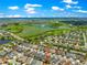 Scenic aerial view of a well-maintained community near a golf course and water features at 1751 Brandenburg Ct, The Villages, FL 32163