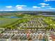 Elevated aerial view of community near golf course, lakes, highlighting its attractive environment and location at 1751 Brandenburg Ct, The Villages, FL 32163