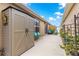 Clean patio with outdoor storage and comfortable seating surrounded by manicured landscaping and lush greenery at 1751 Brandenburg Ct, The Villages, FL 32163