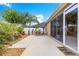 Landscaped backyard featuring patio, flowering plants, palms and gravel at 1751 Brandenburg Ct, The Villages, FL 32163