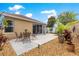 Landscaped backyard featuring patio, flowering plants, palms and rock border at 1751 Brandenburg Ct, The Villages, FL 32163