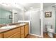 Bright bathroom features tile floors, dual vanity, and walk in shower at 1751 Brandenburg Ct, The Villages, FL 32163