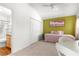 Bright bedroom with closet, ceiling fan, carpet and an adjacent bathroom with bathtub, shower and vanity sink at 1751 Brandenburg Ct, The Villages, FL 32163