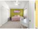 Well-lit bedroom features a pink daybed, closet, and nice floors at 1751 Brandenburg Ct, The Villages, FL 32163