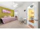 Well-lit bedroom features a pink daybed, closet, and adjacent office space at 1751 Brandenburg Ct, The Villages, FL 32163