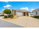 Charming home featuring an attached two car garage and a well maintained front yard with decorative landscaping at 1751 Brandenburg Ct, The Villages, FL 32163