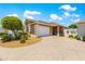 Charming home featuring an attached two car garage and a well maintained front yard with decorative landscaping at 1751 Brandenburg Ct, The Villages, FL 32163