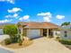 Charming home featuring an attached two car garage and a well maintained front yard with decorative landscaping at 1751 Brandenburg Ct, The Villages, FL 32163