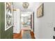 Inviting foyer with hardwood floors, a decorative chandelier, and views into the dining and living areas at 1751 Brandenburg Ct, The Villages, FL 32163