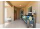 Welcoming front porch area featuring a decorative bench, colorful pillows, and a lovely view to the yard at 1751 Brandenburg Ct, The Villages, FL 32163