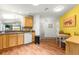 Open kitchen design featuring wooden cabinets, tiled backsplash, and a breakfast nook at 1751 Brandenburg Ct, The Villages, FL 32163