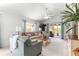 Comfortable living room with sliding glass doors to outdoor patio area and tropical accents at 1751 Brandenburg Ct, The Villages, FL 32163
