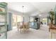 Spacious living room with light-colored carpet, slider to the patio, and overhead ceiling fan at 1751 Brandenburg Ct, The Villages, FL 32163