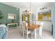 View of the dining room and kitchen with nautical decor and overhead lighting at 1751 Brandenburg Ct, The Villages, FL 32163