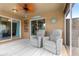 Covered patio with comfortable seating, ceiling fan, and stylish decor, perfect for relaxing outdoors at 1751 Brandenburg Ct, The Villages, FL 32163