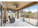 Enclosed sunroom with large windows, comfortable seating, ceiling fan, and tropical plants, bringing the outdoors in at 1751 Brandenburg Ct, The Villages, FL 32163
