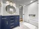Bathroom featuring vanity with gold hardware and a shower-tub combo with built-in niche at 1922 Se 13Th St, Ocala, FL 34471