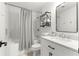 A white bathroom featuring a shower with white tiling and a modern vanity at 1922 Se 13Th St, Ocala, FL 34471