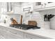 Close-up of the kitchen's stove top with white subway tile backsplash and quartz countertops at 1922 Se 13Th St, Ocala, FL 34471