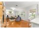 Bright living room featuring hardwood floors, a brick fireplace, and ample natural light at 1922 Se 13Th St, Ocala, FL 34471