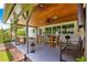 A spacious outdoor patio area featuring a wooden ceiling and dining table at 1922 Se 13Th St, Ocala, FL 34471