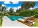 An in-ground swimming pool surrounded by concrete and lounge chairs at 1922 Se 13Th St, Ocala, FL 34471