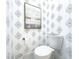 Elegant powder room with designer wallpaper and a modern painting at 1922 Se 13Th St, Ocala, FL 34471